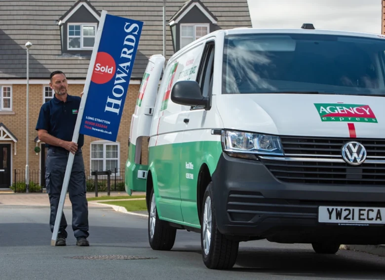Agency signboard and van on site
